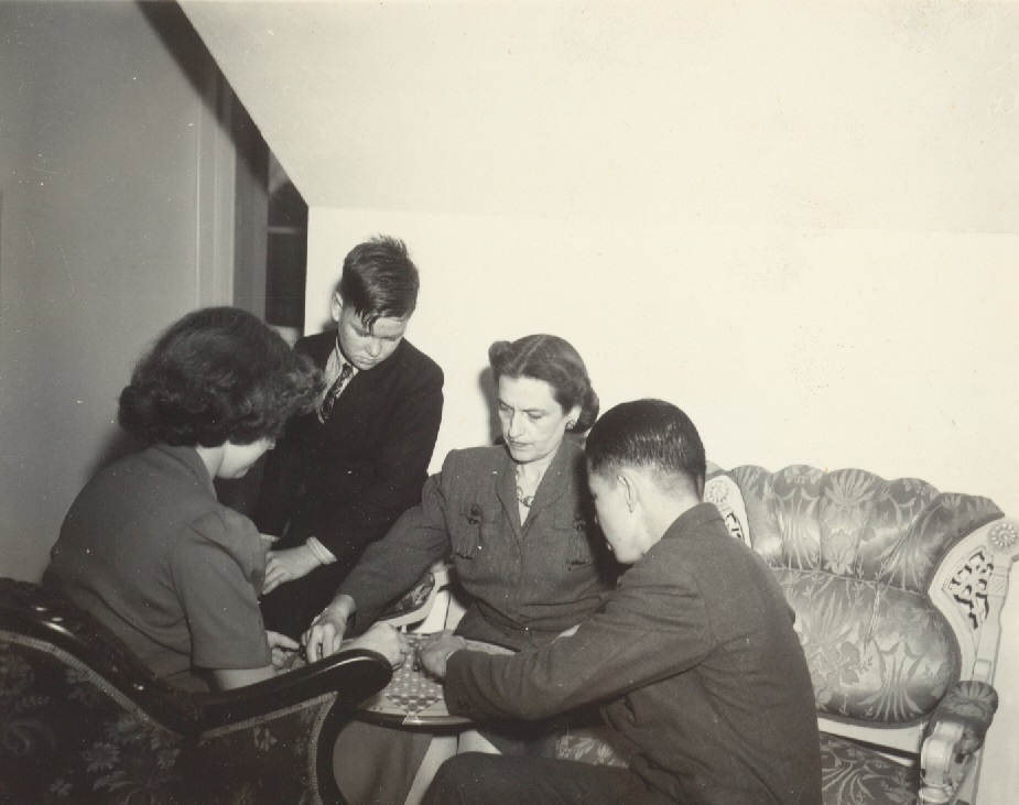 Florida's First Lady, Mary Holland, playing Chinese checkers with her house guests at the Governor's Mansion in Tasllahassee (December 1942). Seated around the table are Gwendolyn Willcocks, Allen Shelton, Mrs. Holland, and Albert W. Thompson (?).