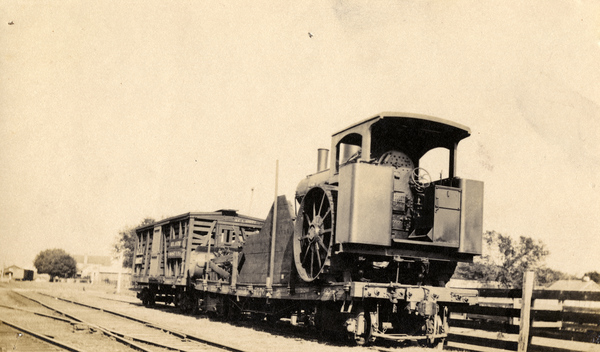 A steam plow arrives on a flat-car for service at Hall City (1912).