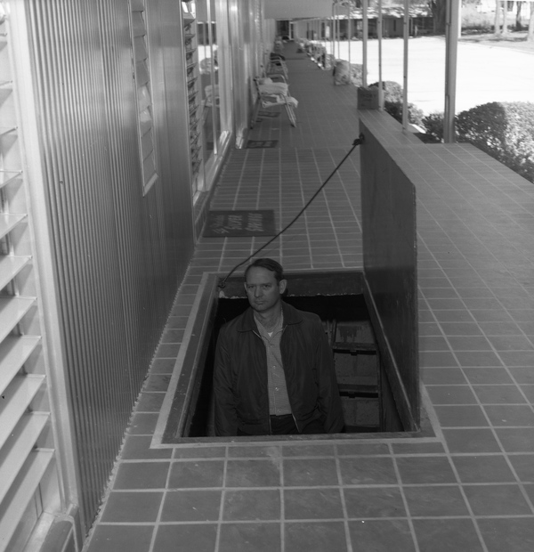 Gilbert Chandler, Jr. emerges from a basement under the Tallahassee Motor Hotel on North Monroe Street. Civil Defense officials said 500 people could potentially take shelter in the space in the event of a nuclear attack (March 2, 1961).