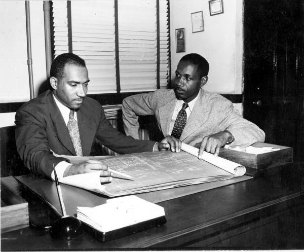 Florida Agricultural and Mechanical College for Negroes president William H. Gray, left, looking over architectural plans, 1946