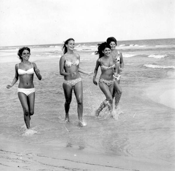 Four bikini clad women frolicking on the beach - Pensacola, Florida