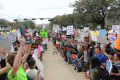 Close-up view showing demonstrators with their signs during the Never Again Rally in Tallahassee.