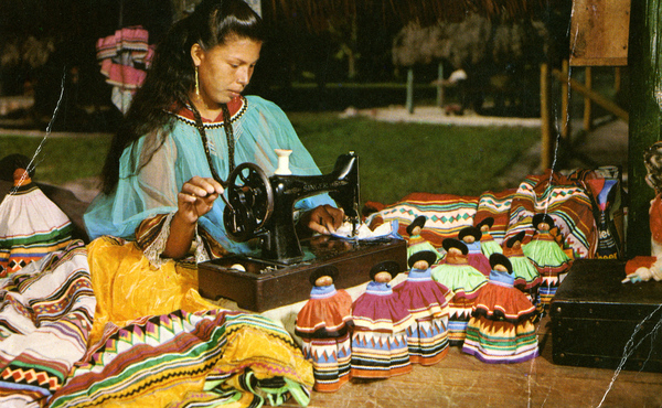 Woman sewing clothing for Seminole dolls