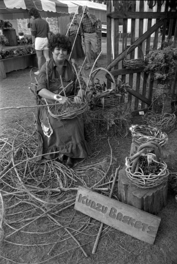 Woman weaving a basket from kudzu vines at Tallahassee Market Days (1986).