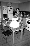 Ana Paz decorating a wedding cake in the kitchen of her home - Miami, Florida