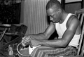 Alphonso Jennings adding a handle to a white oak basket - Lamont, Florida