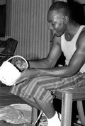 Alphonso Jennings looking at a completed white oak basket - Lamont, Florida