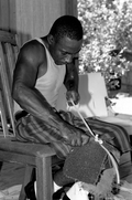 Alphonso Jennings cutting white oak into strips to make a basket - Lamont, Florida