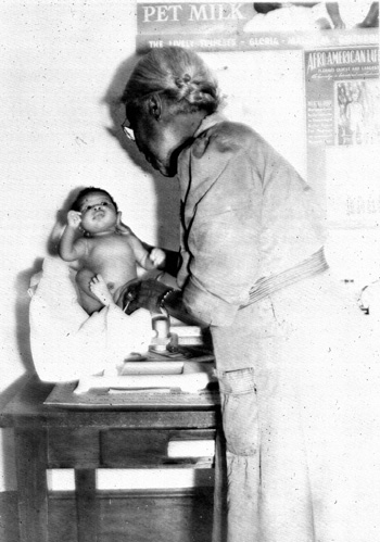 Nurse McGreen weighing an infant: Leon County, Florida (1944) 