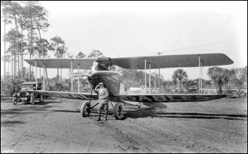 Man posing in front of a biplane, part of Mabel Cody's Flying Circus: Coral Gables, Florida (1922)