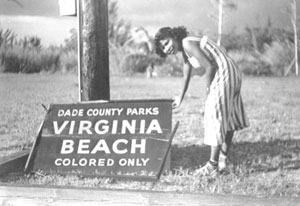 Woman by sign blown down during hurricane: Virginia Beach, Florida (1950)