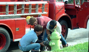 Key West Fire Department members connecting hard suction hose to fire hydrant : Key West, Florida (1984)