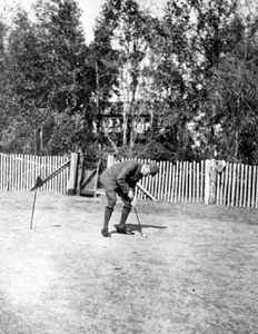 Dr. Tennent Ronalds putting on golf course: Leon County, Florida (ca. 1907)