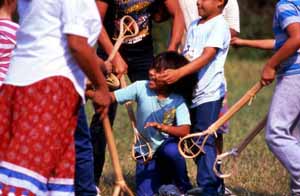 Seminole children playing stick ball: Big Cypress Seminole Indian Reservation (1989)