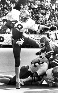 FSU's Mark Lyles hurdles University of Florida players for a broken field scoring run: Gainesville, Florida (1979)