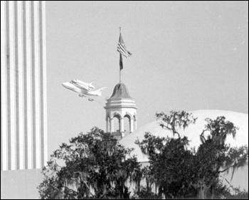 Space shuttle Discovery flying over Florida's capitol building (1992)