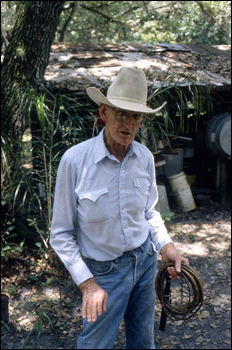 Cow whip maker George "Junior" Mills holding whip: Okeechobee, Florida (1994)