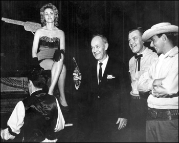 Florida Governor Farris Bryant poses with employees of Six Gun Territory tourist attraction at the Florida State Fair (196-)