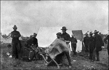 Trooper at work cutting hair between drill calls: Tampa, Florida (1898)