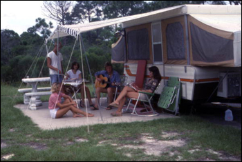 People picnicking near camper at St. Andrews State Park: Panama City, Florida (1977)