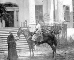 Ellen Call Long leads a horse ridden by a lady in front of "The Grove": Tallahassee, Florida