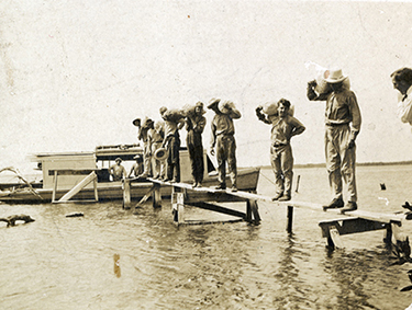 Transferring produce grown on Mound Key (early 1900s)