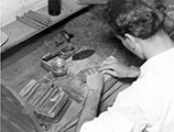 Employee hand rolling a cigar