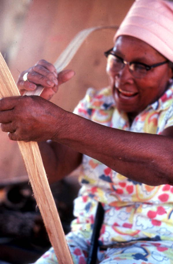 Lucreaty Clark peeling strips of white oak to make baskets (not after 1979)