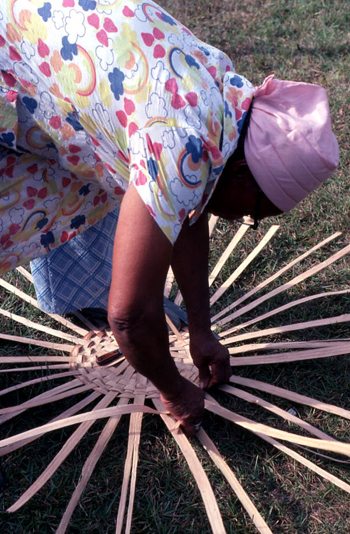 Lucreaty Clark hand weaving strips of white oak to make basket (not after 1979)