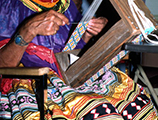 Lottie Shore weaving beads to use on Seminole dolls