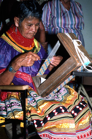 Lottie Shore weaving beads to use on Seminole dolls: White Springs, Florida (1984)