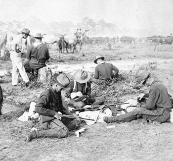 Rough Riders filling belts with cartridges