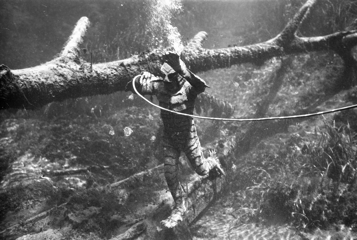 Ricou Browning as Gill Man breathing through an air hose while filming Revenge of the Creature at Silver Springs, 1954. Photo by Bruce Mozert.