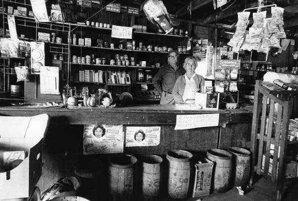 John Henry Pittman and his wife at the counter of their general store in Two Egg (circa 1970).