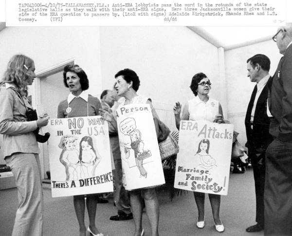 Anti-ERA lobbyists speaking with lawmakers in the Florida Capitol rotunda, 1975