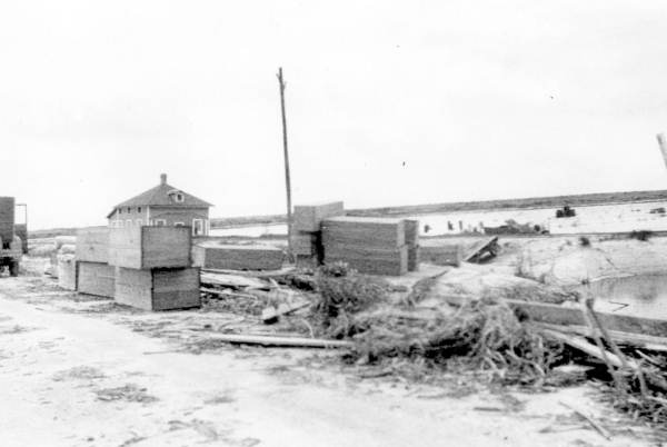 Makeshift coffins stacked alongside the road between Belle Glade and Pahokee after the Okeechobee Hurricane of 1928.