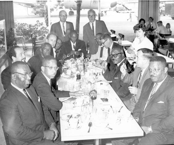 The released clergymen and their supporters dining at the airport restaurant before flying home, August 7, 1964.