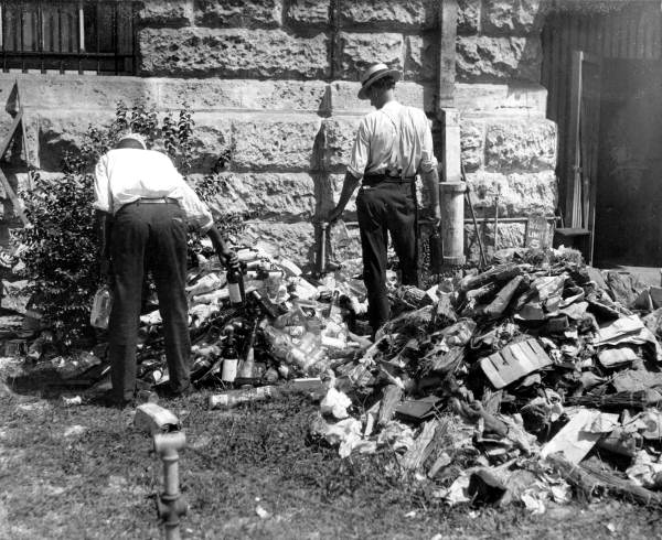 Police destroying confiscated liquor - Miami, Florida.