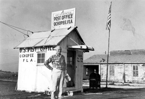 Postmaster Sidney H. Brown in front of the Ochopee Post Office. Brown managed to save the records of the post office from the fire that destroyed this building's predecessor in 1953 (photo circa 1960s).