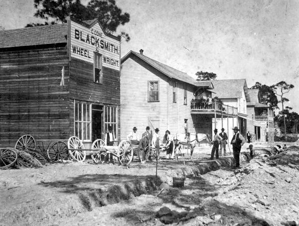 North Miami Avenue in Miami (1896). The building second from the left contained a store owned by T.N. Gautier on the ground floor and a boarding house on the second floor run by Gautier's wife.