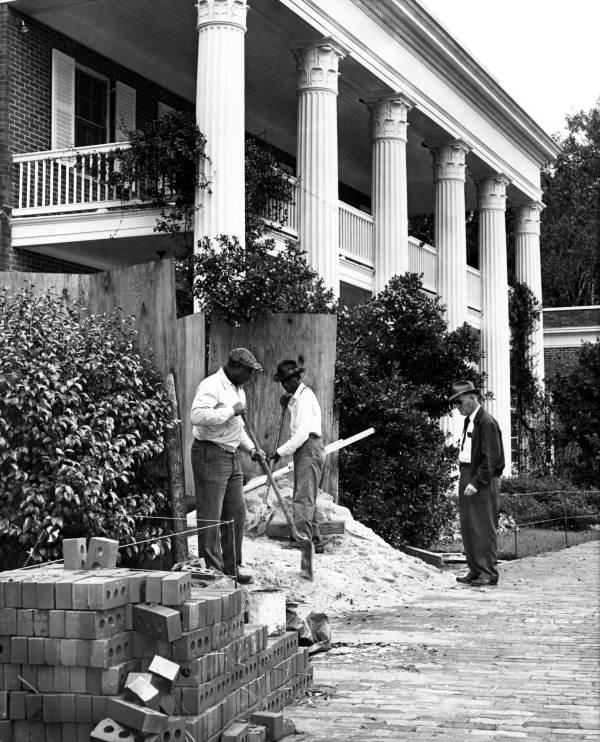 Workers prepare to build thickened walls around the basement of the governor's mansion in Tallahassee so it could be used for a fallout shelter. The man at right is Charles P. Walker, who had served as the superintendent of the executive mansion for 20 years when this photo was taken (December 18, 1961).