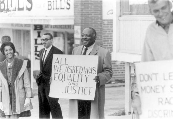 Musician Count Basie joining civil rights demonstrators in front of the Mecca