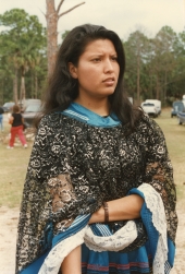 Close-up view of a young Seminole woman in traditional clothing at the Brighton Seminole Reservation tribal festival.