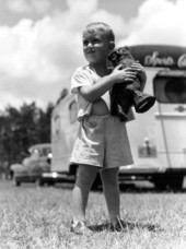 Michael Sadler holding a sculpture stands outside a trailer - Dead Lakes, Florida