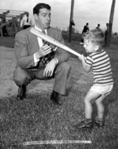 New York Yankee Joe DiMaggio showing 3 year old Larry Valencourt how to hold a bat - West Palm Beach, Florida.