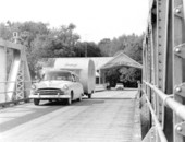 Car and trailer crossing a bridge - Astor, Florida.