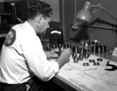 A worker inspecting finished beryllium parts at the Visioneering Company - Sarasota, Florida