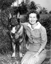 Outdoor portrait of the Governor's wife Mrs. Farris Bryant with the family dog.