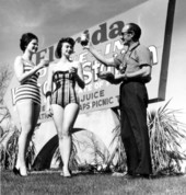 Unidentified ladies and a man in front of the welcome sign - Havana, Florida