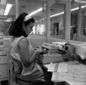 Woman preparing architectural materials for computer at Rader & Associates in Miami, Florida.